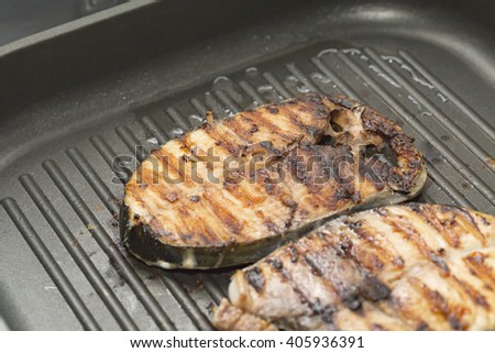 burnt fish in pan.
