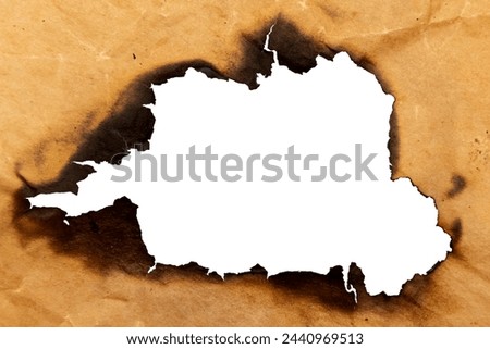 Burnt hole in yellow paper. Burnt paper