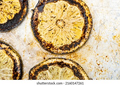 Burnt lemon slices on metal baking sheet drink garnish and flavoring