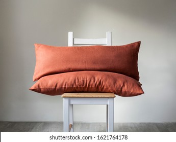 Burnt Orange Lumbar Pillows Set Of 2 On Wooden Chair. Orange Farmhouse Style Pillows In Emty Room