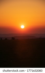 Burnt Orange Sunset Over The Hill