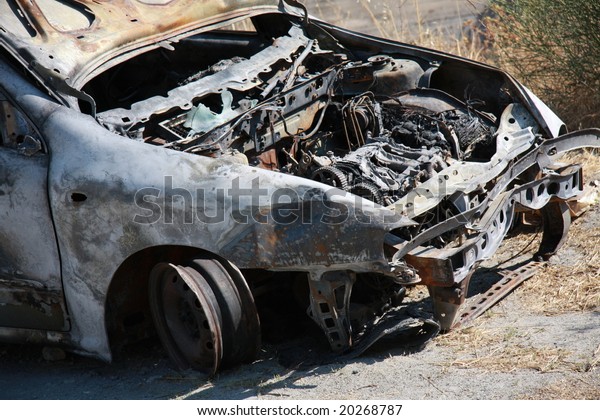 Burnt out car in the\
countryside