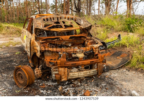 A burnt out car left\
to rot in the coutryside, just another one of many social issues\
around the world.