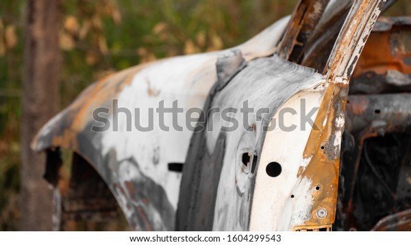 Burnt out\
car. Burnt steel frame of a passenger car and a broken exhaust\
pipe. Abandoned car after a fire or explosion. The concept of a\
traffic accident and vandalism or crime.\
4k