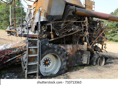 Burnt out combine harvester in field - Shutterstock ID 710713363
