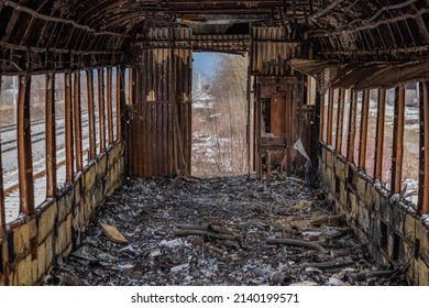 Burnt Out Train Car Or Waggon Interior. Old Railcar After Being Set On Fire. All The Interior Is Burnt And Unrecognisable.