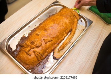 A Burnt Pie On An Iron Tray, Ugly Food In A Shape Of A Cat