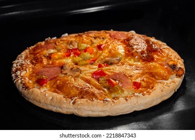 Burnt Pizza With Sausage, Mushroom, Pepper, Mozzarella On Tray In Electric Oven. Italian Cuisine, Homemade Bakery, Fast Food Concept