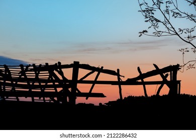 Burnt Roof Before An Orange Sunset