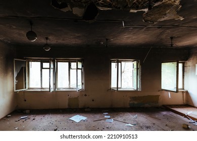 Burnt school interior. Charred walls in black soot. Consequences of fire or war