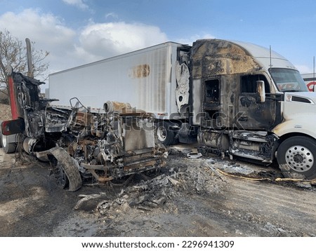 Burnt semi truck and car in the parking lot