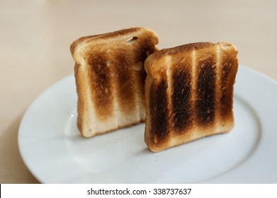 Burnt Toast On A White Plate