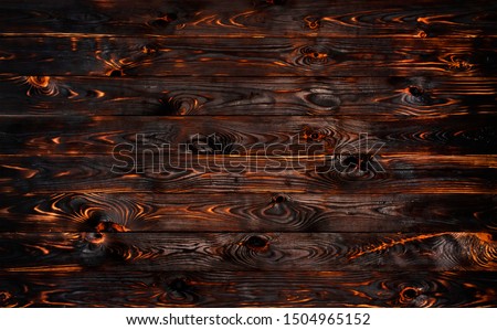 Burnt wooden board, black charcoal wood texture, burned coal barbecue background with copy space, top view