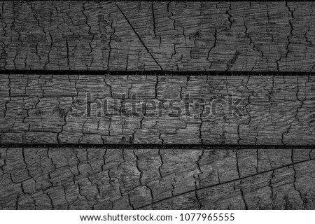 Burnt wooden Board texture.  Smoking wood plank background. Burned scratched hardwood surface.