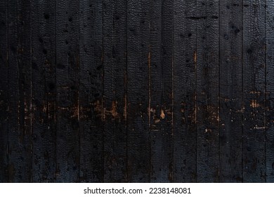 Burnt wooden plank surface after a fire. Details with patterned wood surface texture was charred. Footprint of Fire on Its Surface .Background Texture for use
