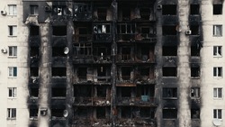 A Burnt-out High-rise In The War Zone. Damage To A Residential Building As A Result Of Artillery Shelling. War In Residential Areas, Broken Windows And Burned Apartments. Armed Conflict In Ukraine