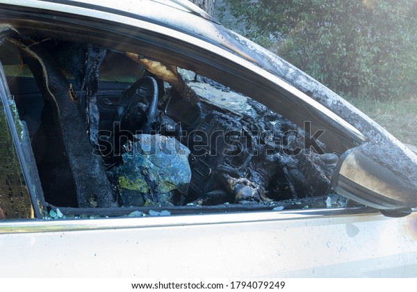 Burnt-out passenger car. Burnt car interior\
close-up. Fire in the car.\
Danger.