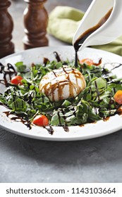 Burrata And Arugula Salad With Balsamic Vinegar Glaze Pouring Over