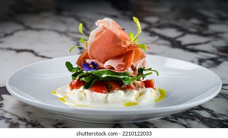 Burrata Cheese With Italian Delicatessen Salad With Parma Ham Slices On White Plate. Burrata With Parma Ham