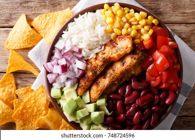 Burrito Bowl With Chicken Grilled, Rice And Vegetables Close-up On The Table. Horizontal Top View From Above, Mexican Style
