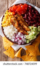 Burrito Bowl With Chicken Grilled, Rice And Vegetables Close-up On The Table. Vertical Top View From Above, Mexican Style
