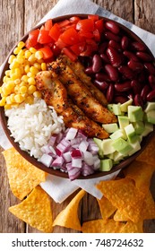 Burrito Bowl With Grilled Chicken And Vegetables Close-up On The Table. Vertical Top View From Above
