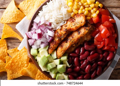 Burrito Bowl With Grilled Chicken And Vegetables Close-up On The Table. Horizontal Top View From Above
