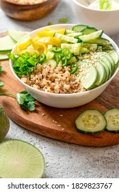 Burrito bowl with quinoa and green vegetables. Salad of quinoa, cucumber, peppers, radishes and celery in a bowl close-up. Healthy diet food, vegetarian food.