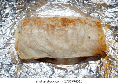 Burrito. Chicken Or Steak Burrito In A Foil Wrapper. Burrito With Chicken, Rice, Cheese, Salsa, Beans, Onions Grilled To Perfection. Lunch Or Dinner Menu. Burritos Are Enjoyed World Wide. 
