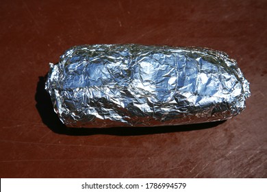 Burrito. Chicken Or Steak Burrito In A Foil Wrapper. Burrito With Chicken, Rice, Cheese, Salsa, Beans, Onions Grilled To Perfection. Lunch Or Dinner Menu. Burritos Are Enjoyed World Wide. 
