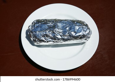 Burrito. Chicken Or Steak Burrito In A Foil Wrapper. Burrito With Chicken, Rice, Cheese, Salsa, Beans, Onions Grilled To Perfection. Lunch Or Dinner Menu. Burritos Are Enjoyed World Wide. 
