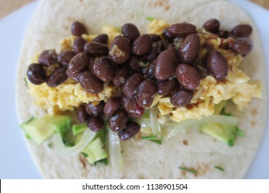                    Burrito with scrambled eggs, black beans, avocado, scallions            