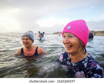 Burry Port, Wales, UK: May 08, 2022: A Group Of Mature Female Friends Swimming In The Sea. The Bluetits Chill Swimmers Ltd Is A Social Enterprise Empowering Our Inclusive Community To Outdoor Dipping.