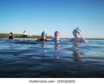 Burry Port, Wales, UK: May 08, 2022: A Group Of Mature Female Friends Swimming In The Sea. The Bluetits Chill Swimmers Ltd Is A Social Enterprise Empowering Our Inclusive Community To Outdoor Dipping.