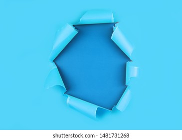 Burst hole background. Blue torn paper. Minimal abstract colorful wallpaper concept. Paper texture, place for text. mockup