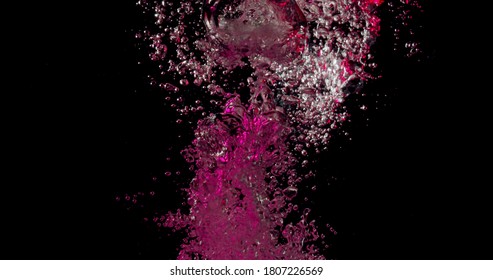 Burst Of Pink Bubbles Plunging Into The Dark Waters And Dispersing.