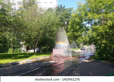 Burst Pipe. The Incident In The City. The Work Of Public Services. From The Leaky Hose Gushing Water Into The Sky. Rainbow In The Air.