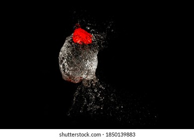 Burst Of Water Balloon On Black Background 