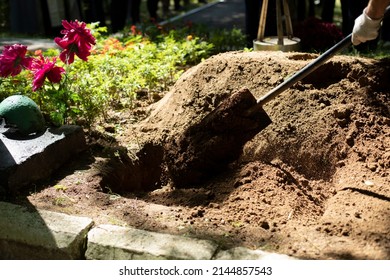 Burying Grave. Funeral Details. Mourning Ceremony. Gravedigger With Shovel. Burial Of Body.