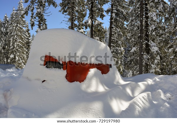 Bus  buried under deep snow after a snow storm\
in the mountain . Snowdrift