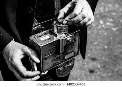 A Bus Conductor Holding An Old Fashioned Bus Ticket Machine