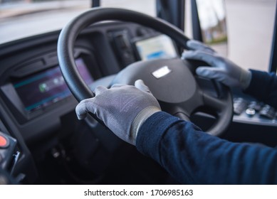 Bus Driver With Mask Puts Protecting Gloves On His Hand In Bus To Protect Himself From The Coronavirus Epidemic. Covid 19. Protect From Corona Virus. Quarantine 2020. Stay Home.