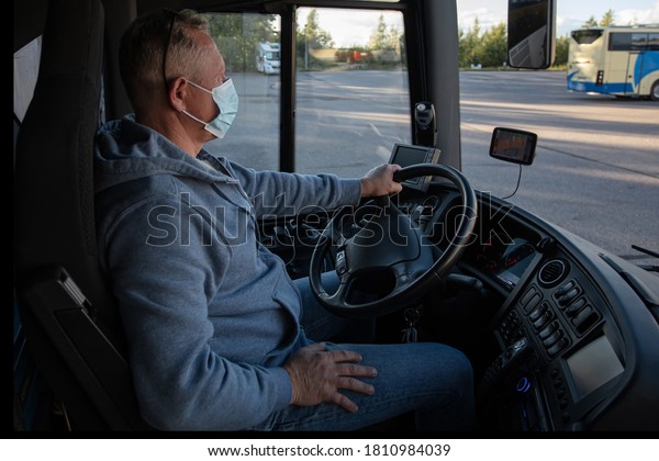 Bus driver in
medical mask, leads the bus
Safe driving during a pandemic,
protection against
coronavirus
