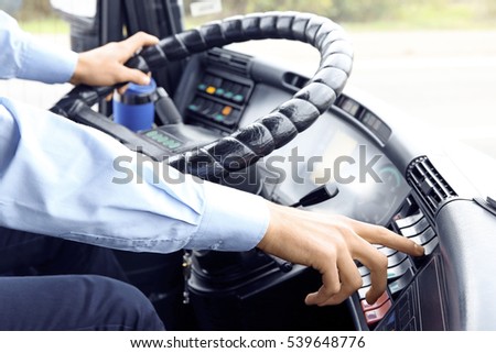 Bus driver pushing button on panel
