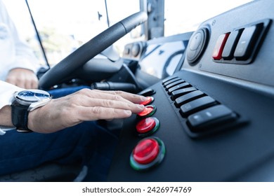 Bus driver sitting in his bus on tour. Transport, transportation, tourism, road trip and people concept - close up of bus driver driving passenger bus. - Powered by Shutterstock
