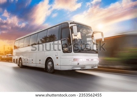 Bus driving moving at high motion blur effect speed on a road in the sunset