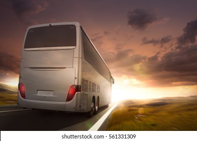 Bus Driving On A Road In The Sunset