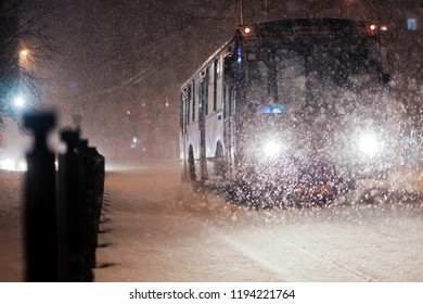 bus in the evening in the snowfall