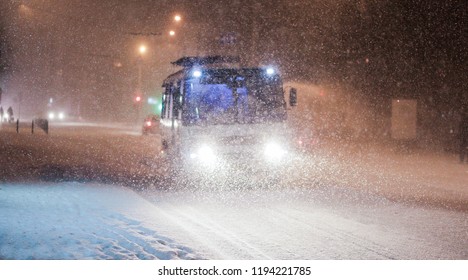 bus in the evening in the snowfall