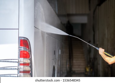 Bus Get Washed From A Washer With Water Jet In Garage 